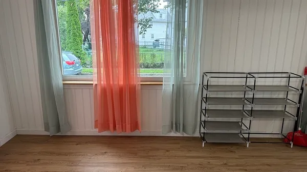 a view of room with window and wooden floor