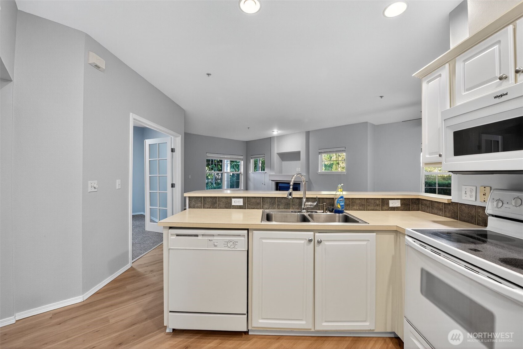 1680 Kennedy Place, Unit A4 DuPont, WA 98327 - Photo 12 of 24 a kitchen with stainless steel appliances granite countertop a sink and cabinets with wooden floor