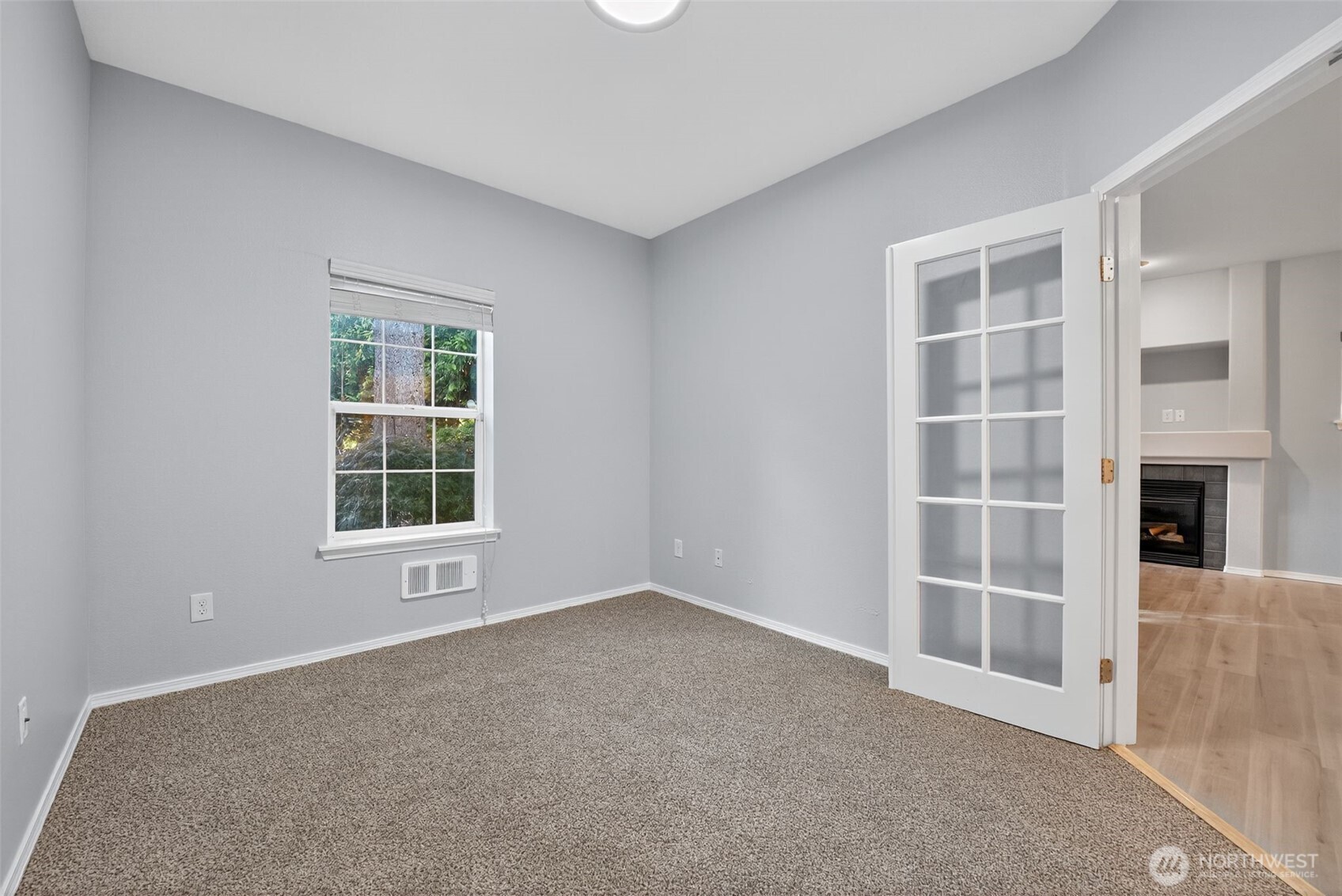 1680 Kennedy Place, Unit A4 DuPont, WA 98327 - Photo 13 of 24 an empty room with a fireplace and windows