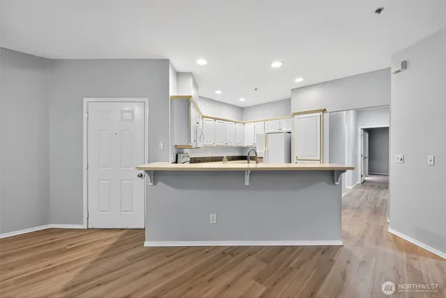 a view of a kitchen with wooden floor