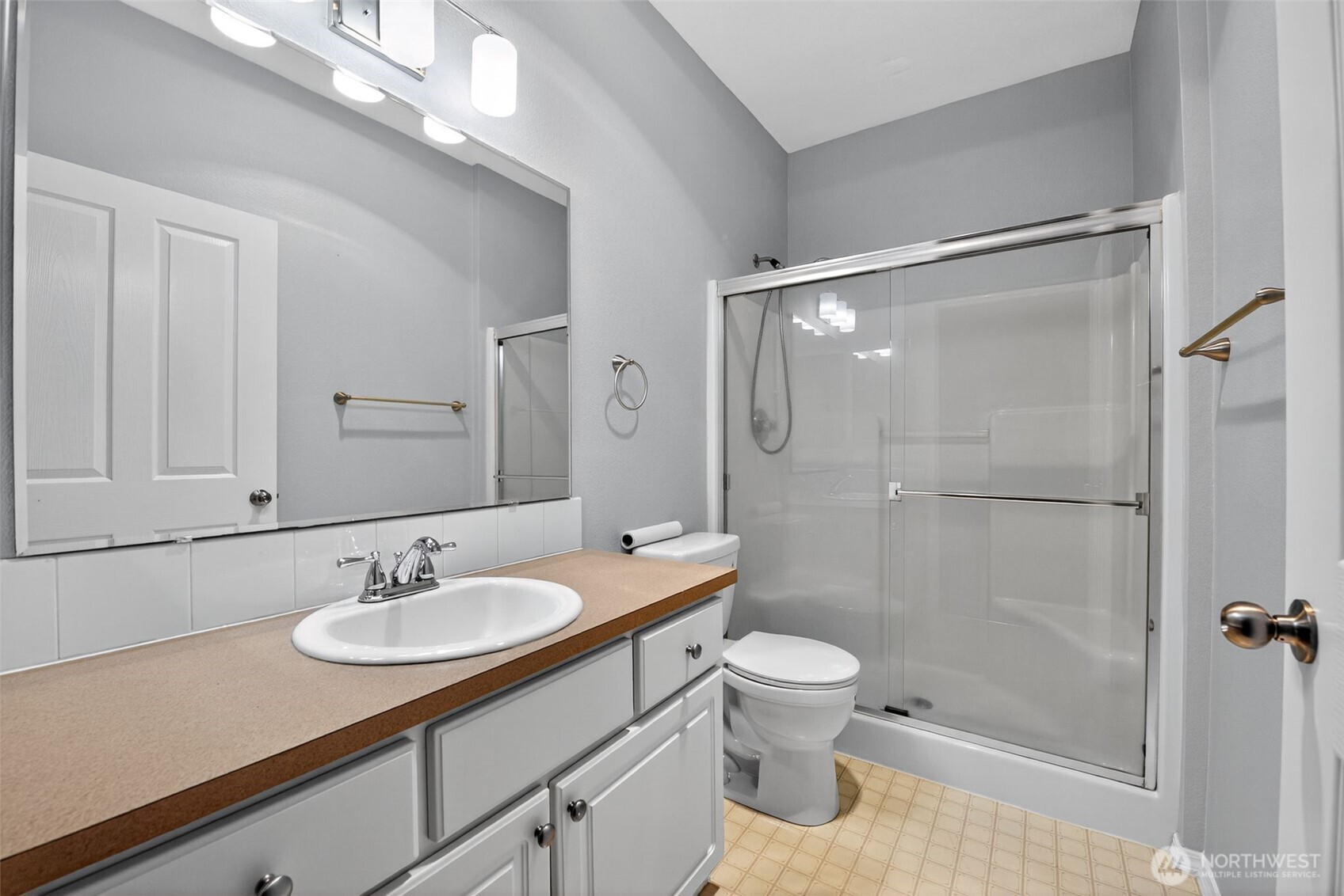 1680 Kennedy Place, Unit A4 DuPont, WA 98327 - Photo 19 of 24 a bathroom with a sink a toilet a mirror and shower