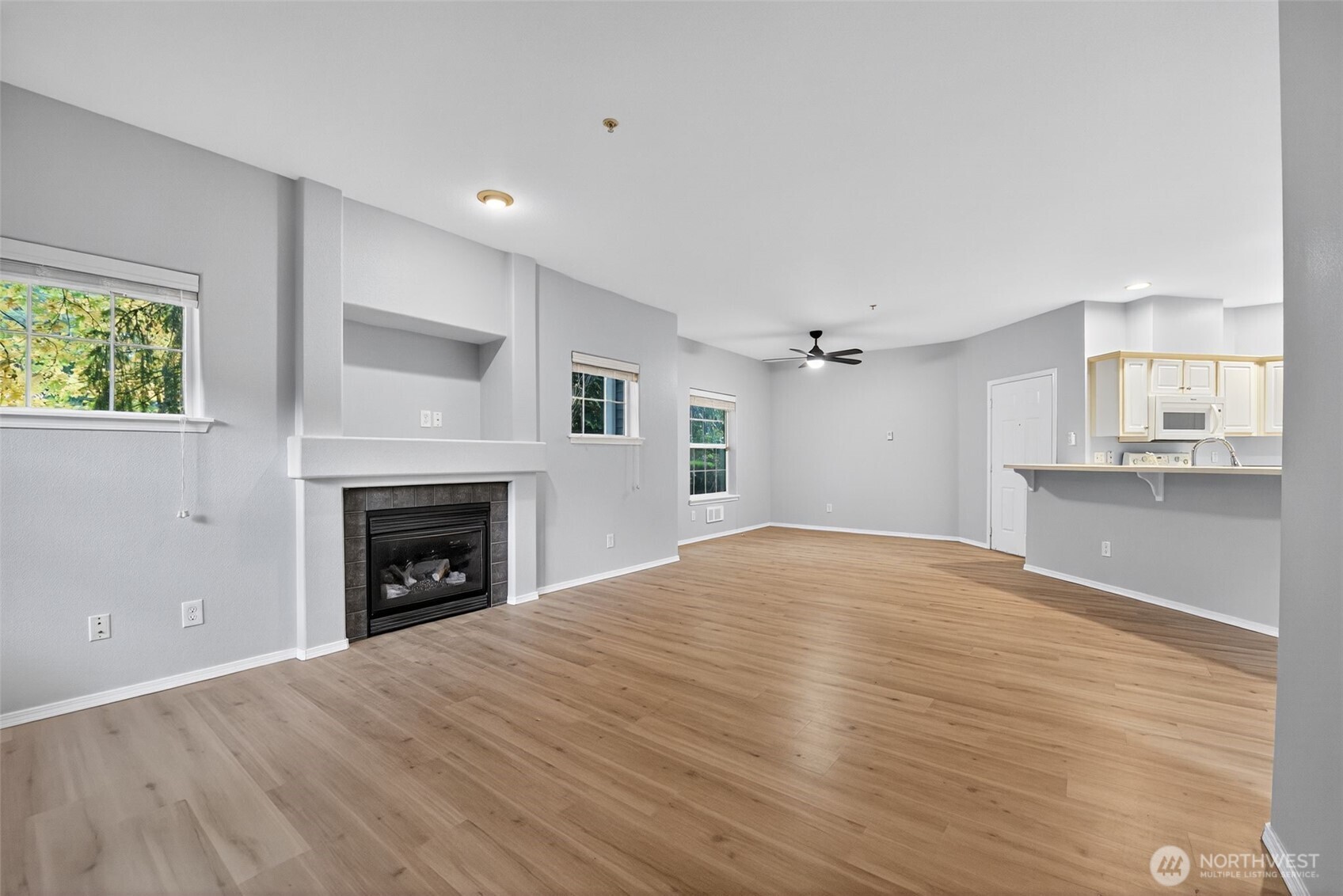 1680 Kennedy Place, Unit A4 DuPont, WA 98327 - Photo 5 of 24 a view of empty room with kitchen and fireplace