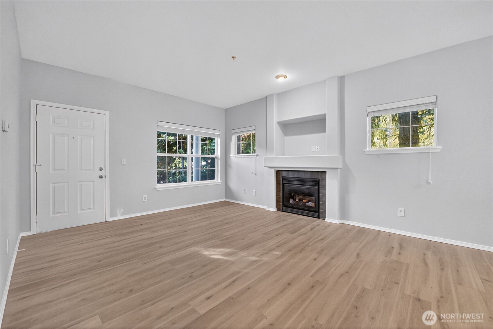 1680 Kennedy Place, Unit A4 DuPont, WA 98327 - Photo 6 of 24 a view of an empty room with a window and fireplace