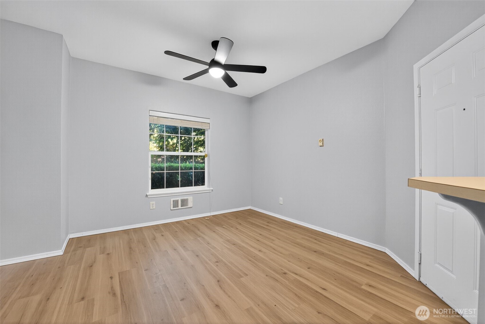 1680 Kennedy Place, Unit A4 DuPont, WA 98327 - Photo 7 of 24 a view of empty room with wooden floor and fan