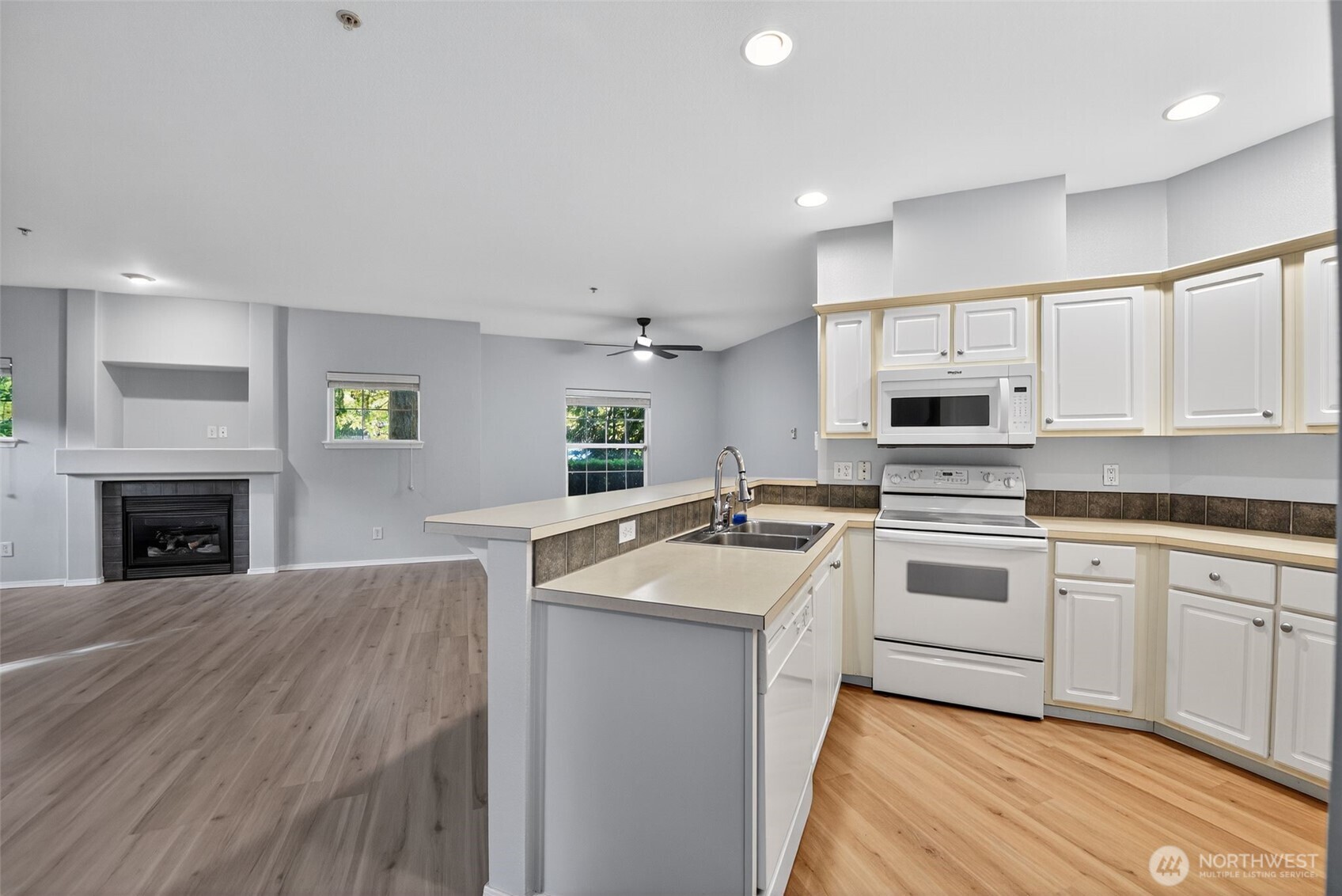 1680 Kennedy Place, Unit A4 DuPont, WA 98327 - Photo 10 of 24 a kitchen with granite countertop a sink stainless steel appliances and cabinets