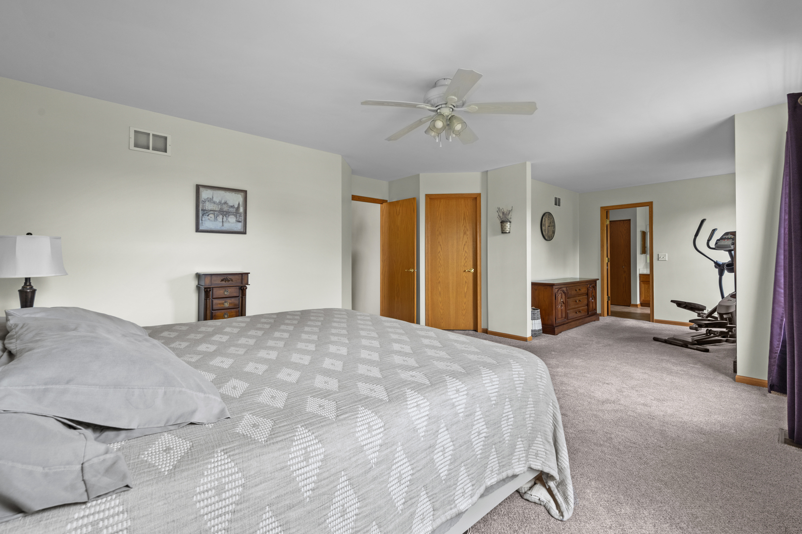614 Wingpointe Drive Aurora, IL 60506 - Photo 19 of 31 a bedroom with a bed and a chandelier