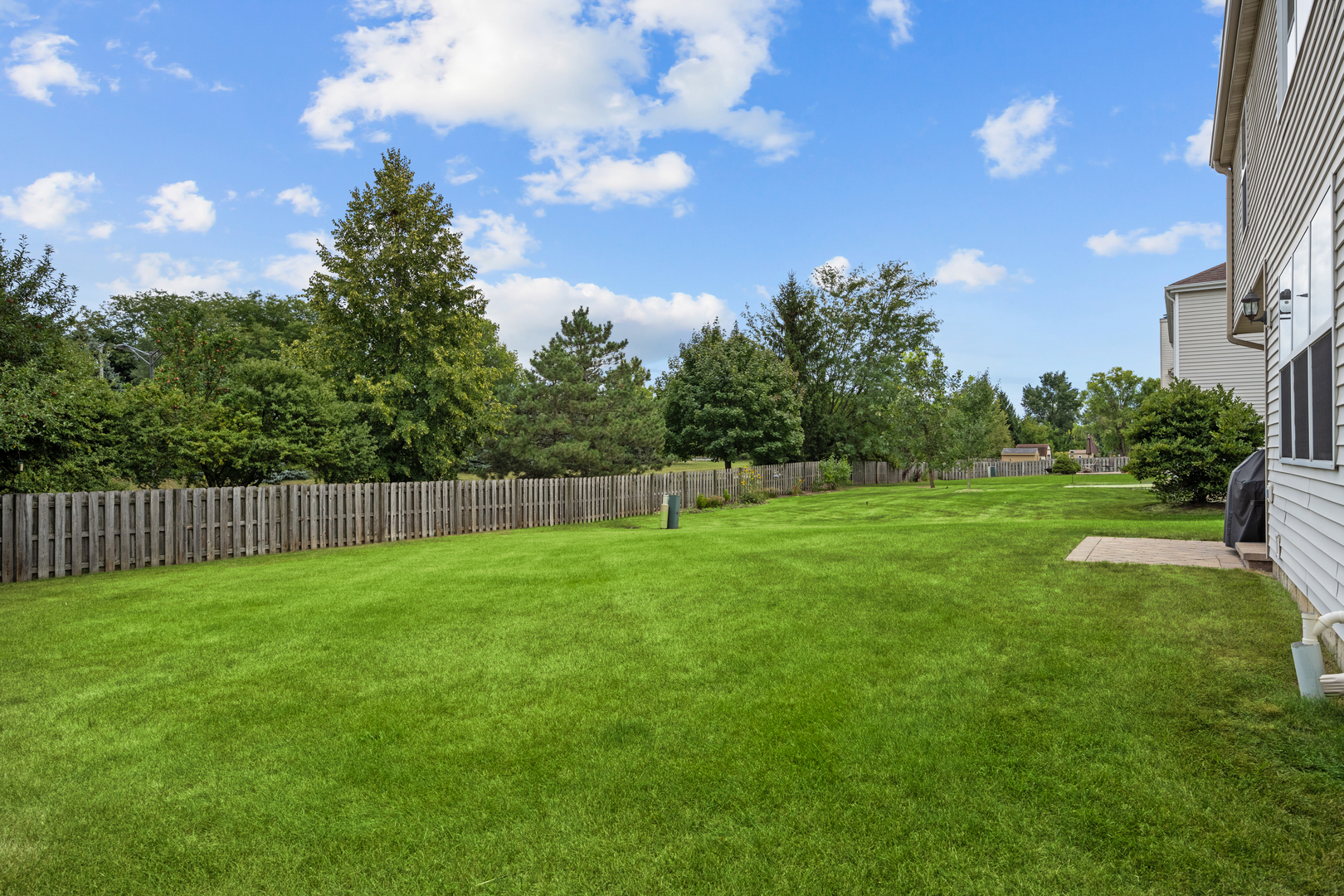 614 Wingpointe Drive Aurora, IL 60506 - Photo 26 of 31 a view of a yard with a fence and trees