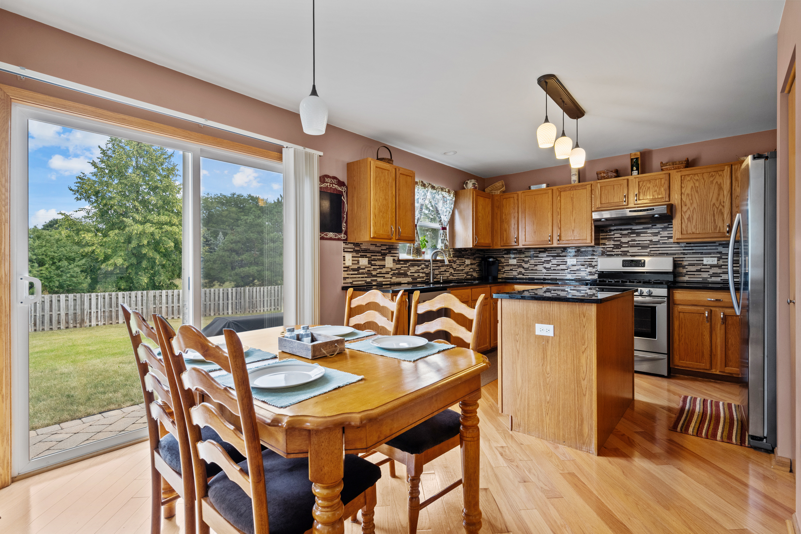 614 Wingpointe Drive Aurora, IL 60506 - Photo 9 of 31 a kitchen with a table chairs sink and cabinets