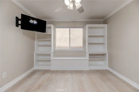 a view of walk in closet with empty room