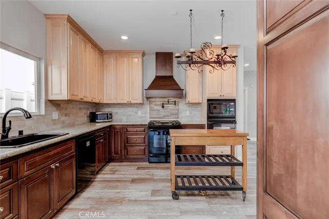 a kitchen with stainless steel appliances granite countertop a stove and a sink