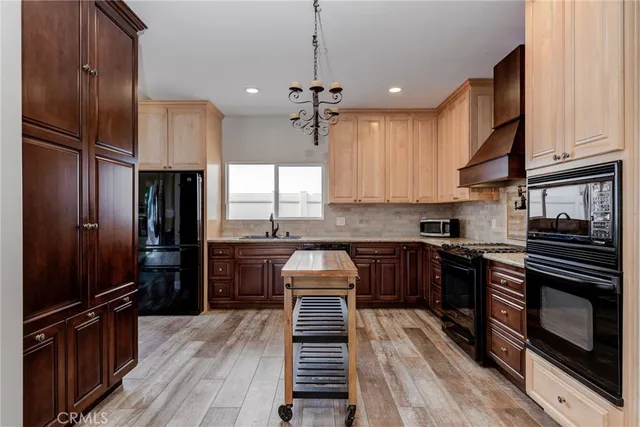 a kitchen with kitchen island granite countertop stainless steel appliances and wooden cabinets