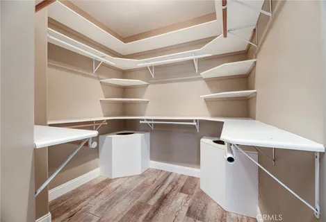 a room with a closet and wooden floor