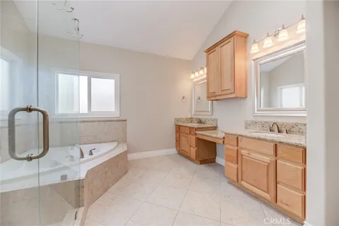 a bathroom with a tub sink and a mirror