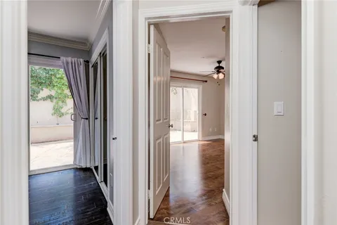 a view of a hallway with wooden floor and closet