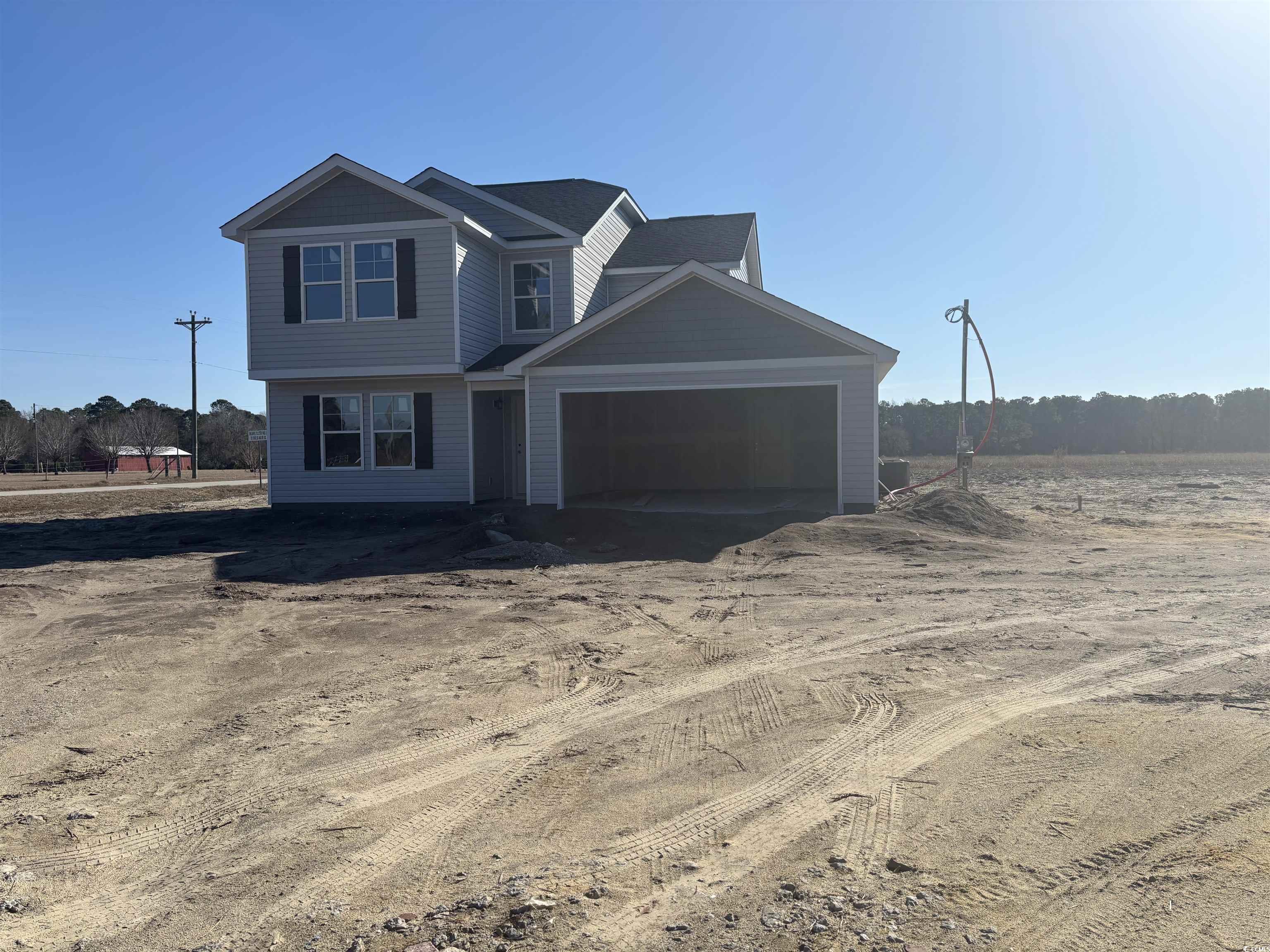View of front of house with driveway and a garage