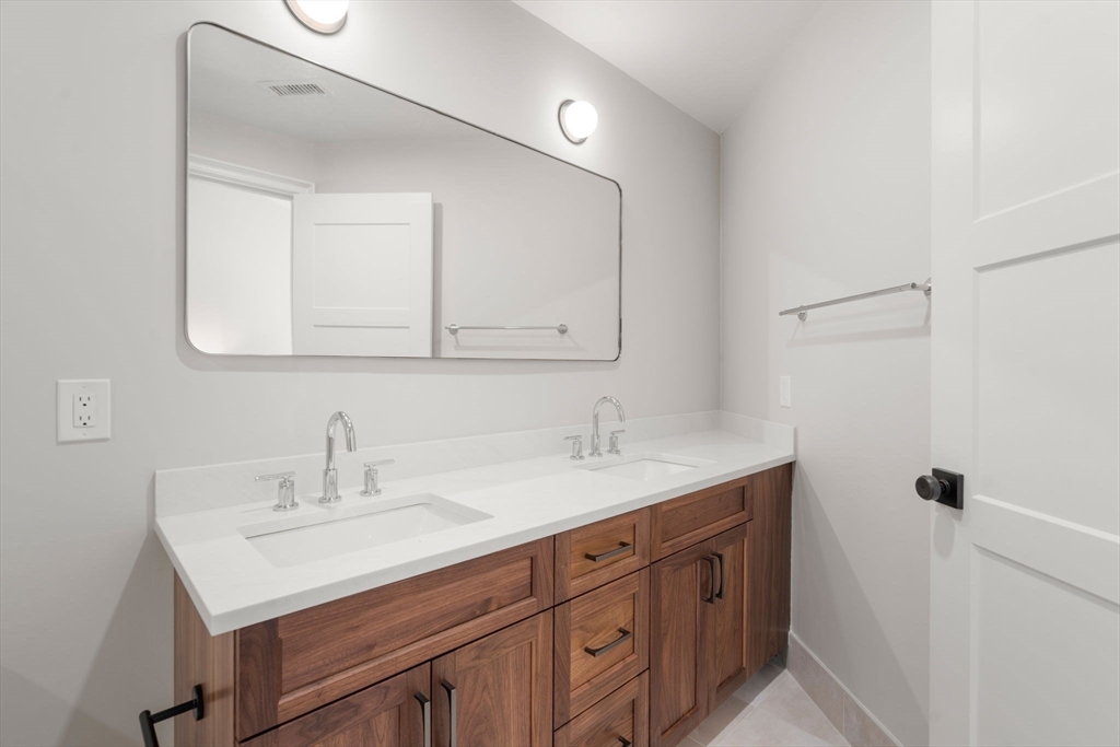 69 Williams Street, Unit 3 Boston, MA 02130 - Photo 16 of 22 a bathroom with a sink a vanity and a mirror