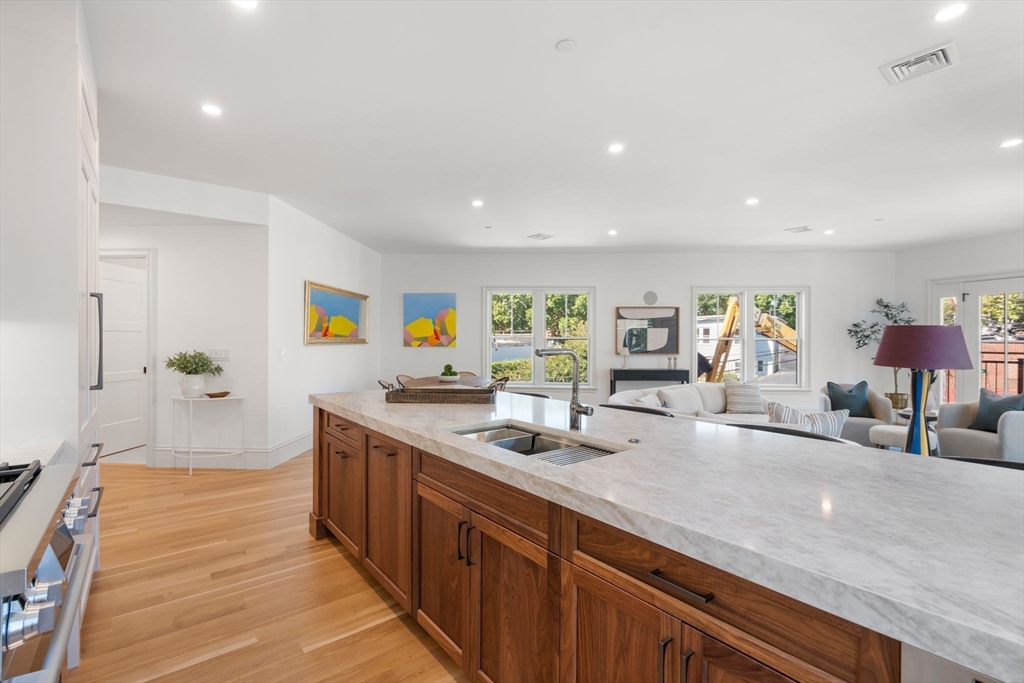 69 Williams Street, Unit 3 Boston, MA 02130 - Photo 4 of 22 a large kitchen with stainless steel appliances a large counter top a stove and a sink