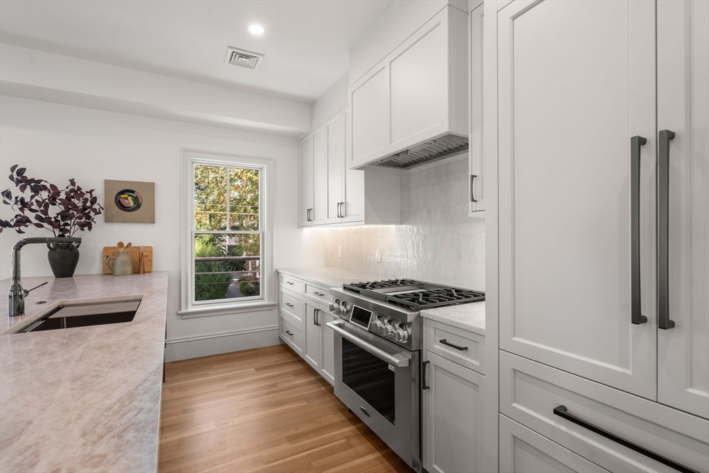 69 Williams Street, Unit 3 Boston, MA 02130 - Photo 5 of 22 a kitchen with stainless steel appliances a stove and a refrigerator