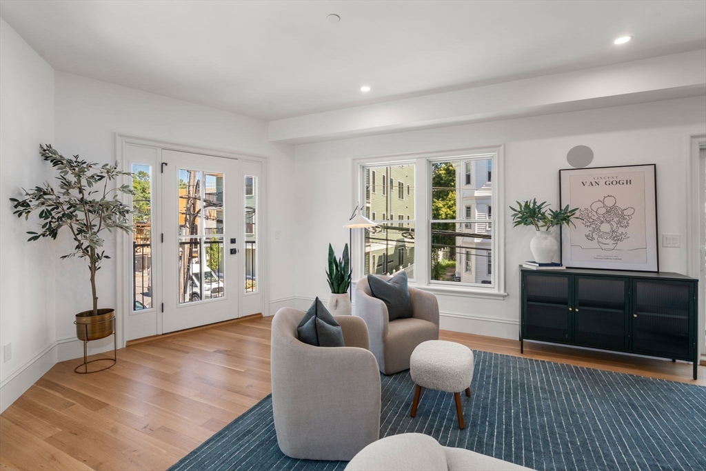 69 Williams Street, Unit 3 Boston, MA 02130 - Photo 9 of 22 a living room with furniture potted plant and a large window