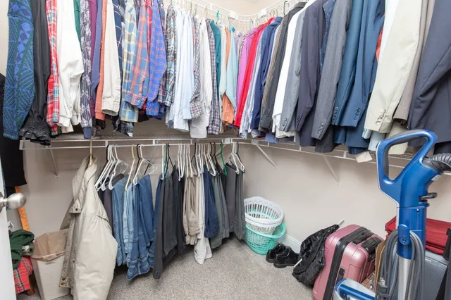 a bathroom with a granite countertop sink a toilet and a mirror