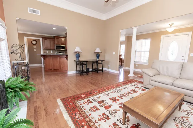 a living room with furniture and a lamp