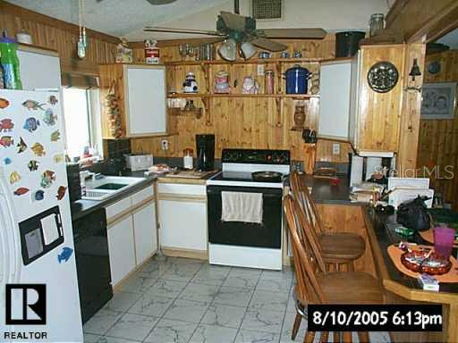 7413 Mitchell Ranch Road New Port Richey, FL 34655 - Photo 3 of 9 a kitchen with stainless steel appliances a stove a sink and a refrigerator