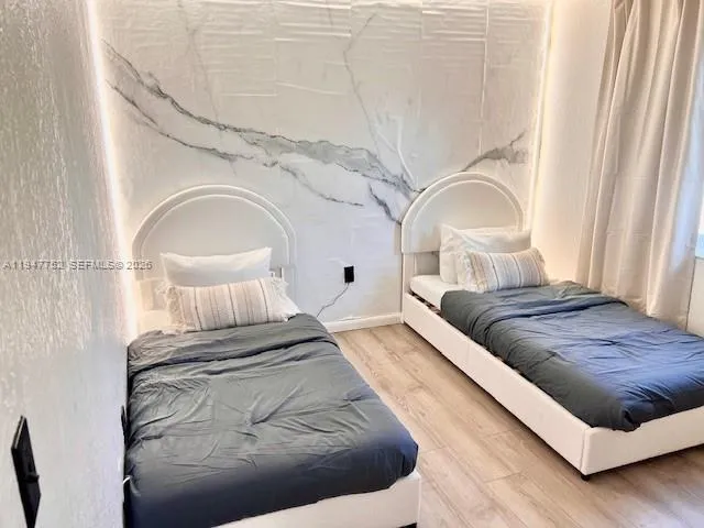 a living room with a bed and a mirror