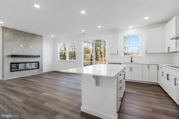 a kitchen with stainless steel appliances granite countertop a sink and cabinets
