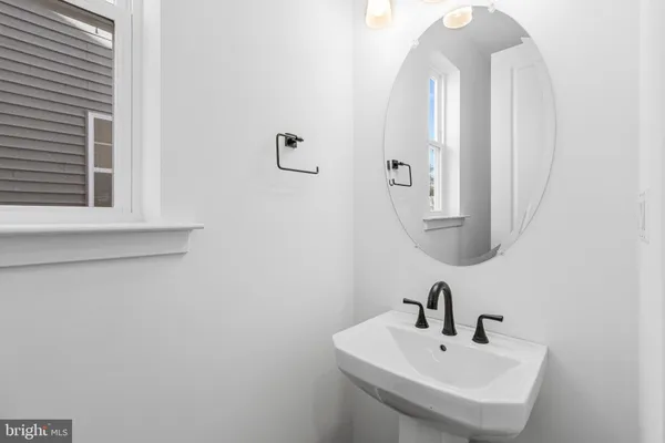 a bathroom with a sink a mirror and vanity