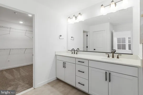 a bathroom with a double vanity sink and a mirror