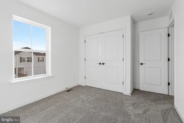 a bathroom with a sink a toilet a mirror and shower