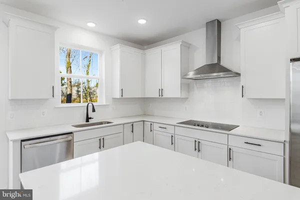a kitchen with stainless steel appliances a sink stove and cabinets