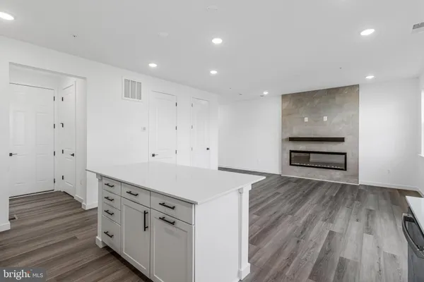 a kitchen with wooden floor and window