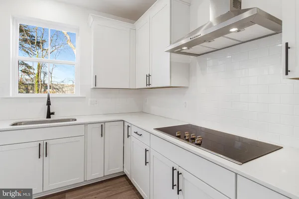 a kitchen with white cabinets and white appliances
