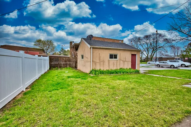a view of a backyard with plants and a garden
