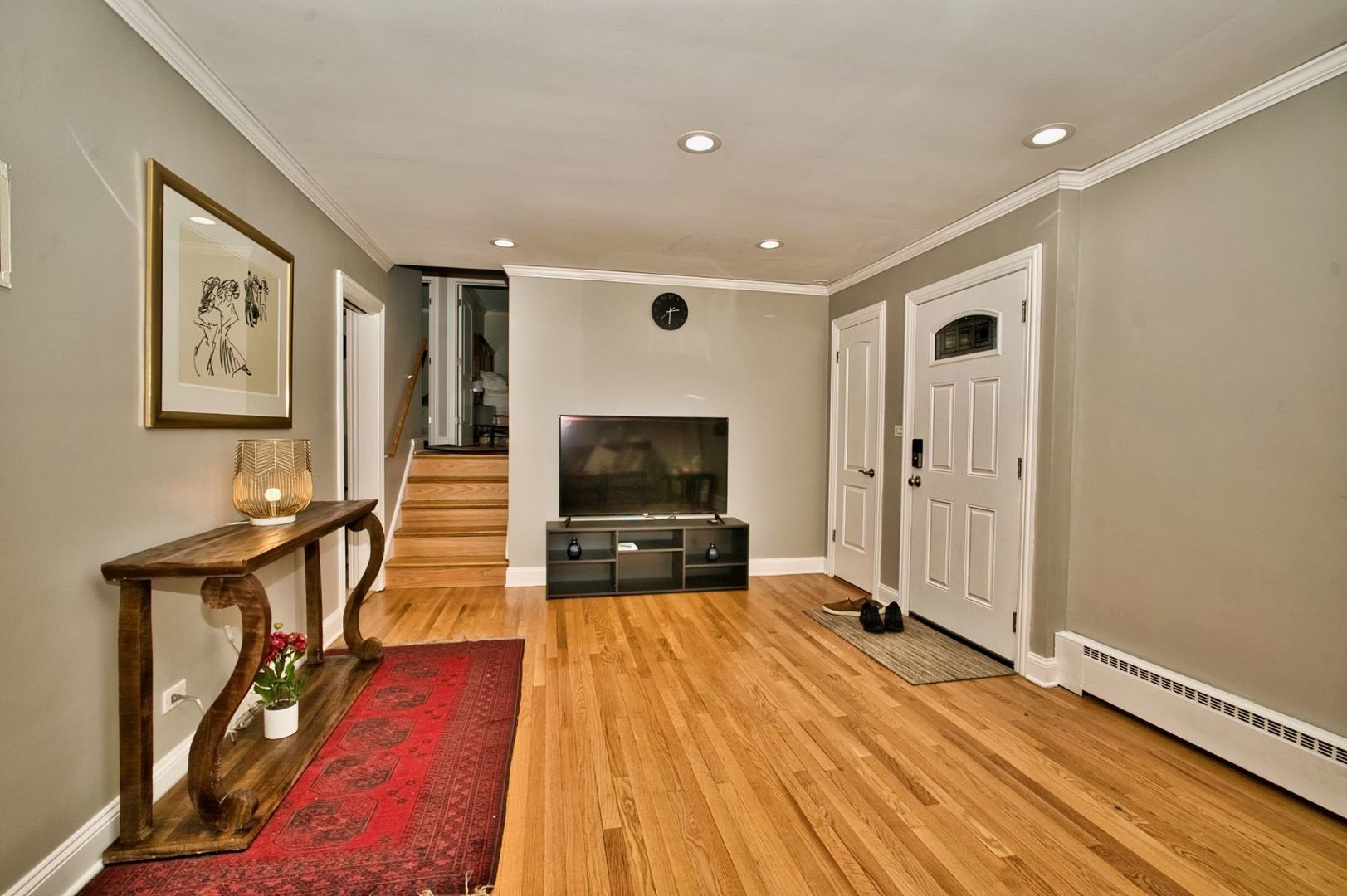 5200 Madison Street Skokie, IL 60077 - Photo 20 of 53 a living room with furniture wooden floor and a flat screen tv