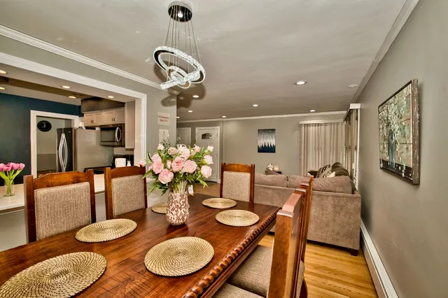 a dining room with furniture a rug and wooden floor