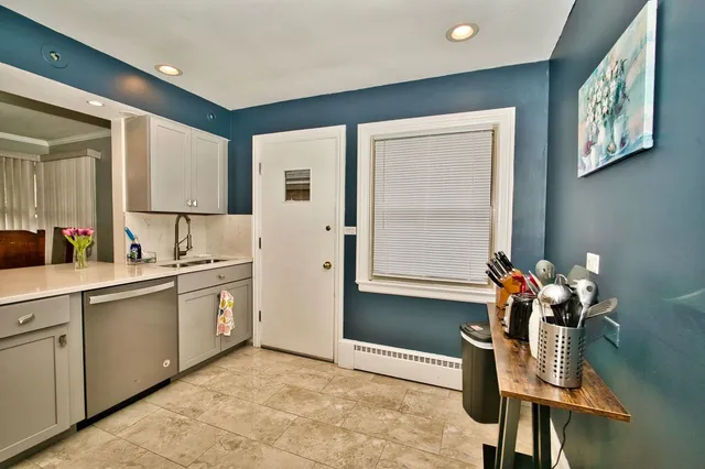 a kitchen with a sink refrigerator and cabinets