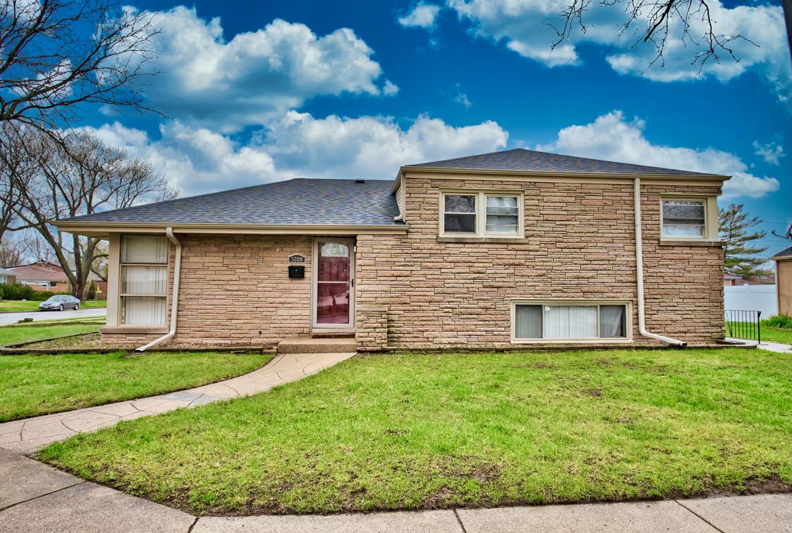 5200 Madison Street Skokie, IL 60077 - Photo 3 of 53 a front view of a house with a yard and garage