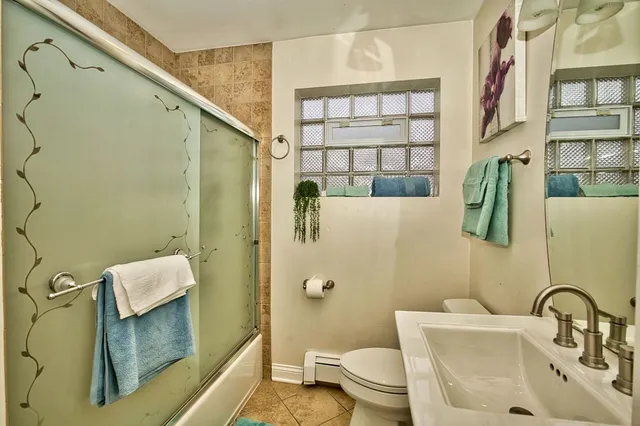 a bedroom with 2 bed and a window