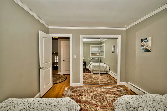 a bedroom with a bed and a view of walk in closet