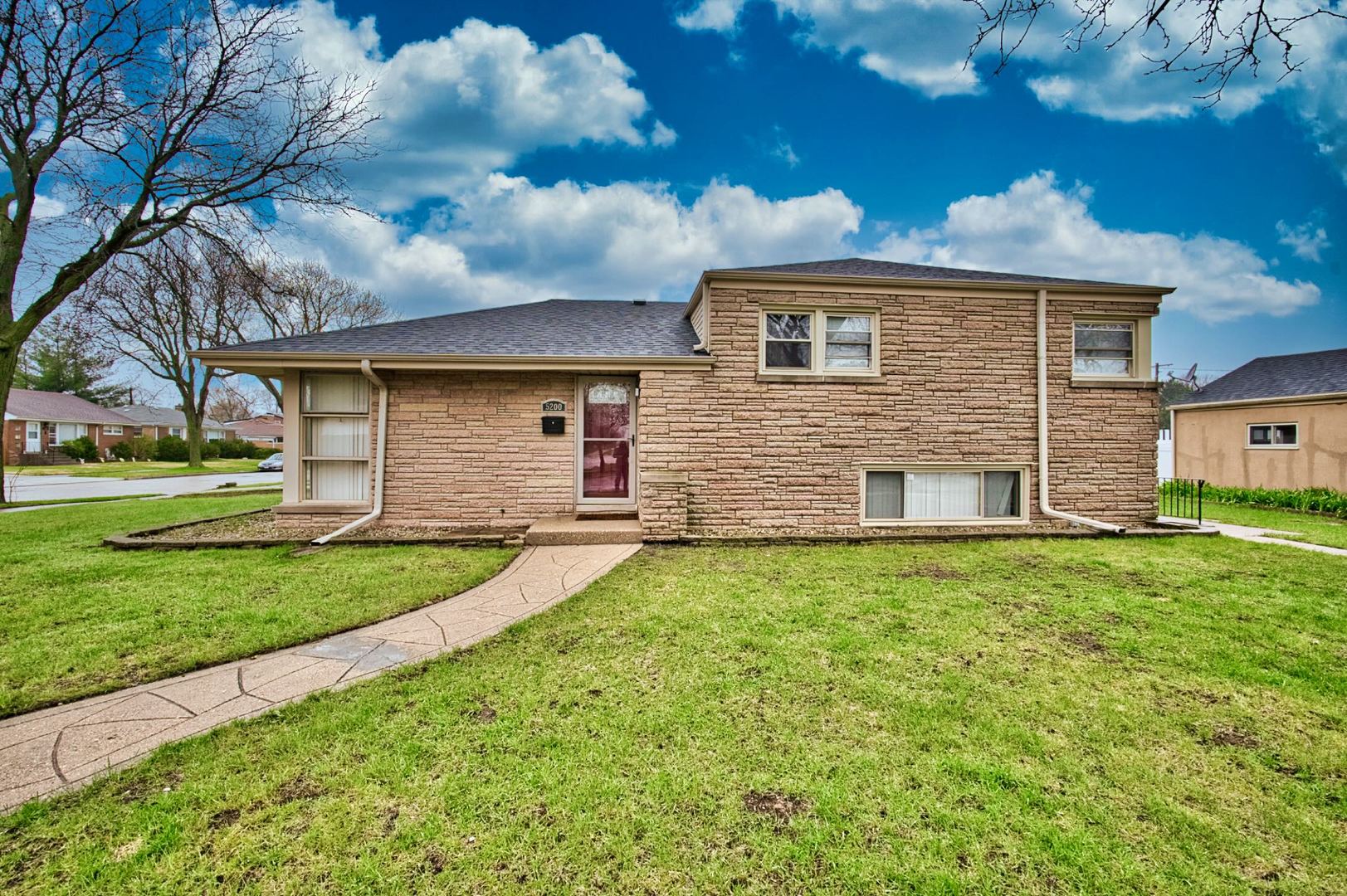 5200 Madison Street Skokie, IL 60077 - Photo 5 of 53 a front view of a house with a yard