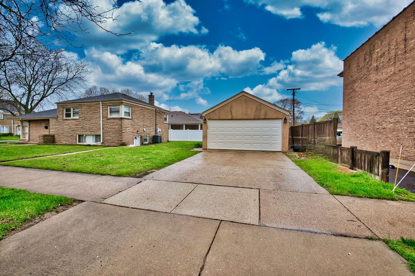 5200 Madison Street Skokie, IL 60077 - Photo 8 of 53 a front view of a house with a yard and garage
