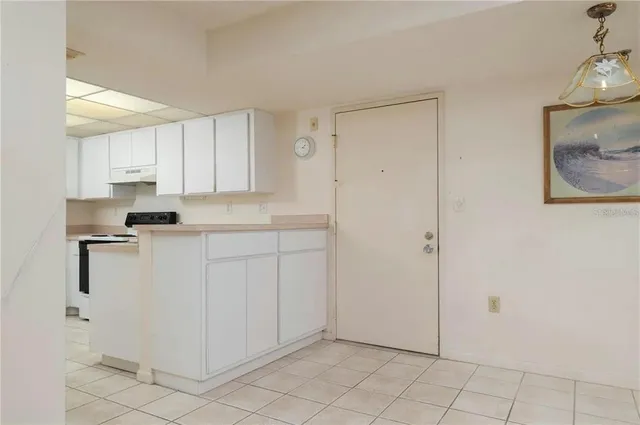 a kitchen with white cabinets and white appliances