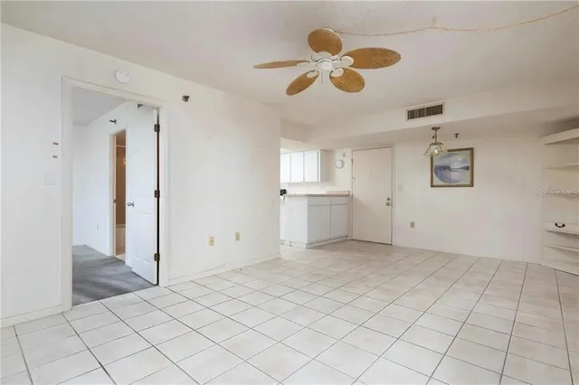 an empty room with closet and windows