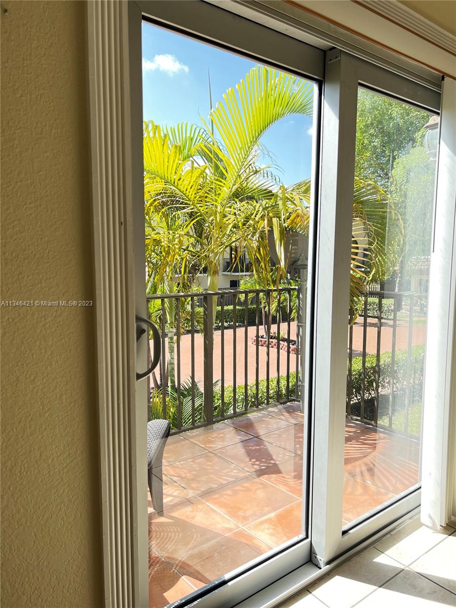 8600 Southwest 109th Avenue, Unit 4209 Miami, FL 33173 - Photo 9 of 15 a view of a glass door with a tv from a window