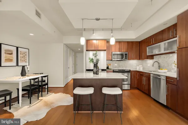 a kitchen with cabinets a sink and appliances