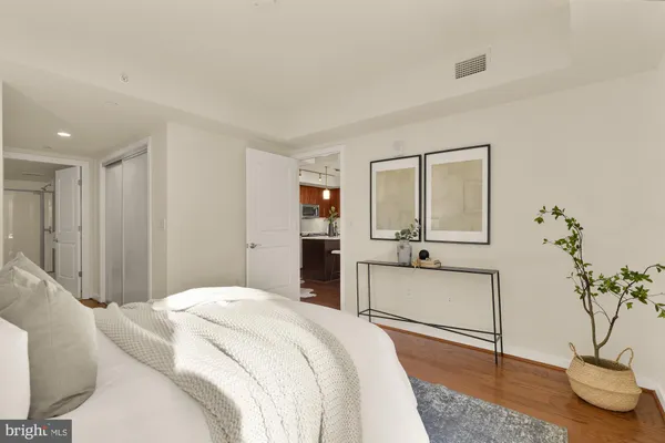 a bedroom with a bed and a potted plant