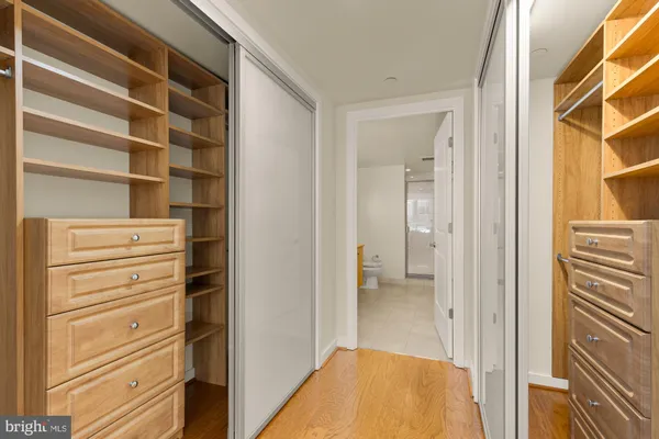 a view of walk in closet with empty racks