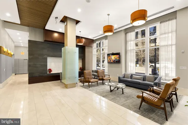 a living room with furniture rug and window